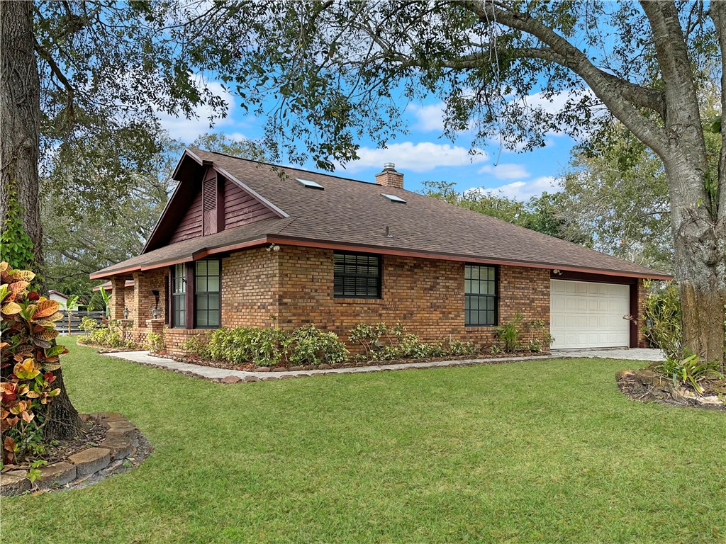 6602 Eden Road Fort Pierce, FL 34951 - Photo 22 of 24 a front view of a house with a garden
