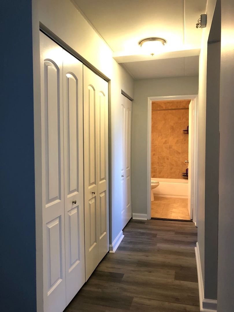 225 South Rohlwing Road, Unit 106 Palatine, IL 60074 - Photo 12 of 17 a view of a bathroom with wooden floor and a window