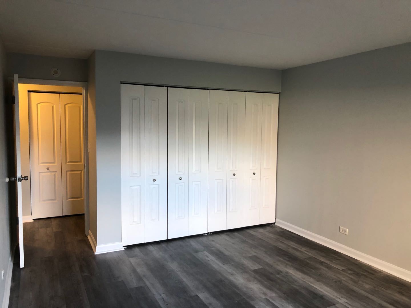 225 South Rohlwing Road, Unit 106 Palatine, IL 60074 - Photo 9 of 17 a view of an empty room with wooden floor and a window