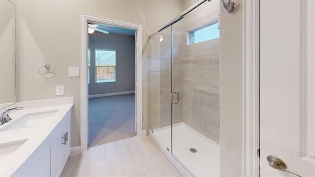 a bathroom with a shower and a sink