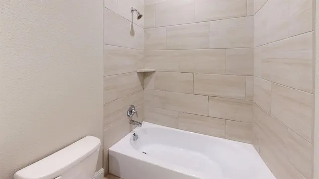 a bathroom with a bathtub and toilet