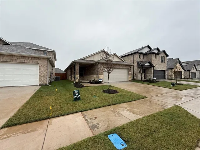 a house with green field in front of it