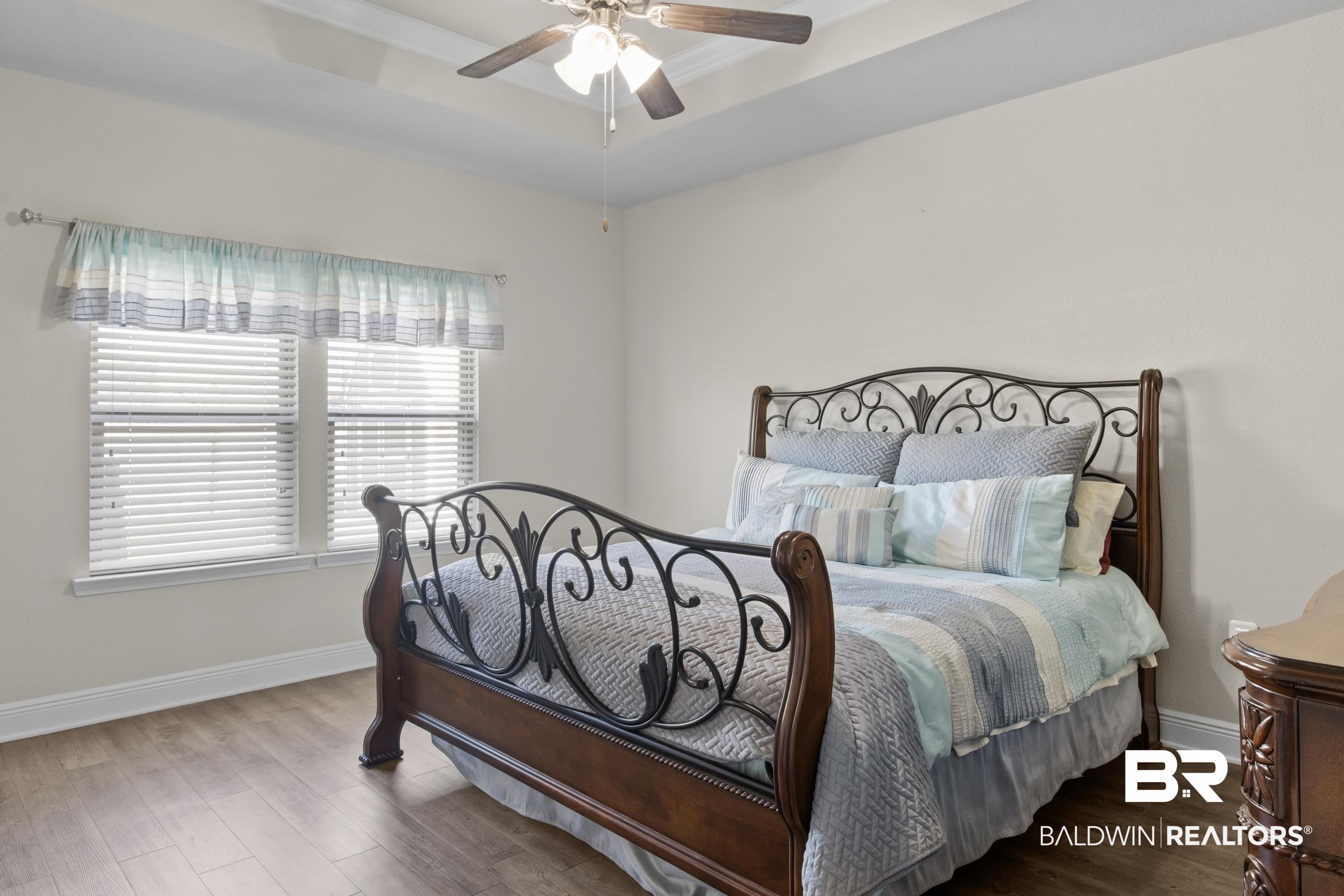 2050 Bourbon Street Foley, AL 36535 - Photo 18 of 32 Bedroom featuring a tray ceiling, ceiling fan, and hardwood / wood-style floors