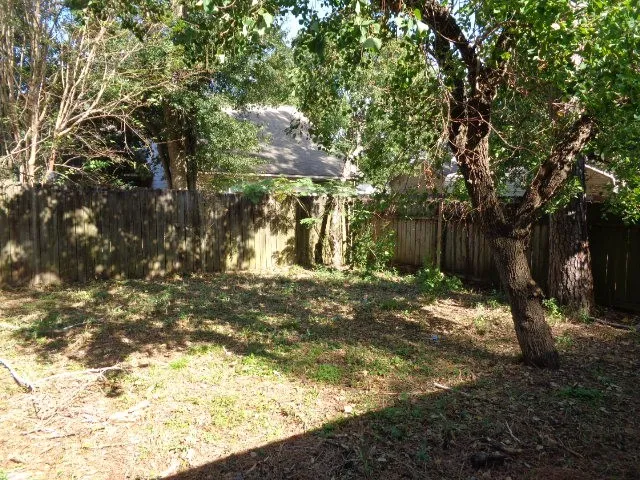 a backyard of a house with large trees