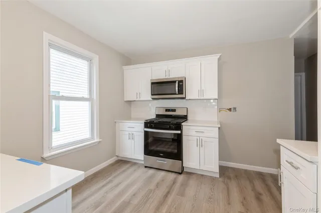 a kitchen with a stove a sink and a microwave