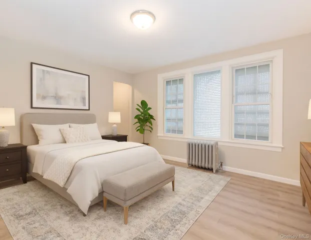 a bedroom with a large bed and a window