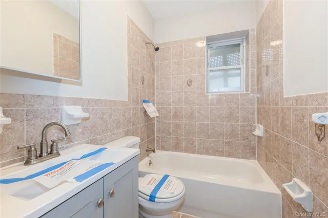 a bathroom with a sink a toilet and bathtub