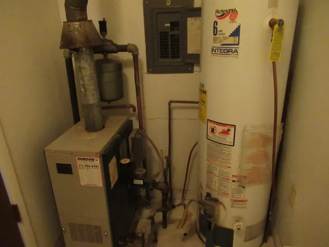 a white toilet sitting next to a white sink and vanity