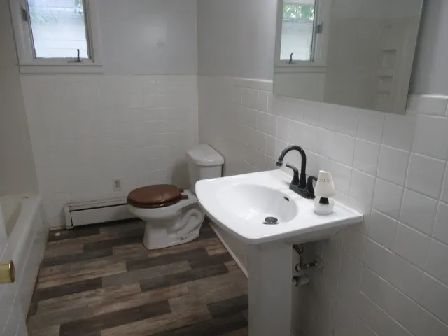 a bathroom with a sink toilet and a window