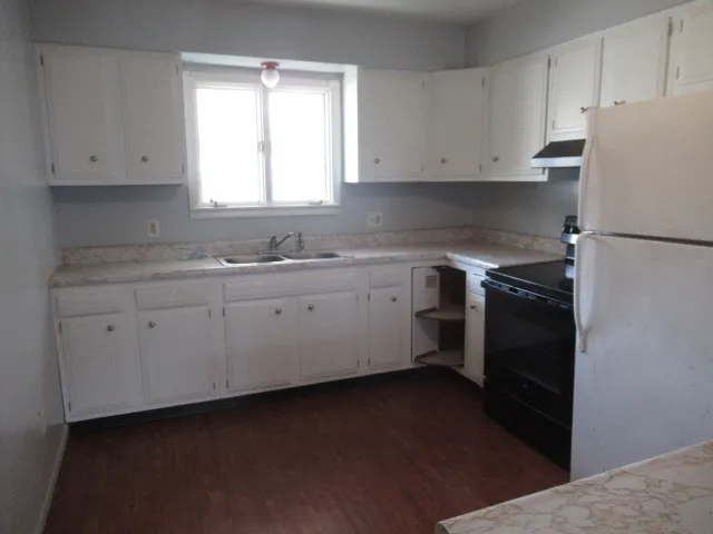 a kitchen with a white cabinets and white appliances