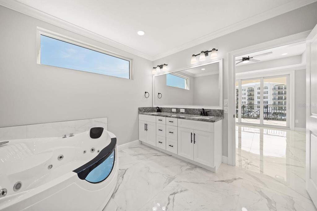 211 Dolphin Point, Unit 301 Clearwater, FL 33767 - Photo 19 of 48 a bathroom with a granite countertop sink a toilet and shower