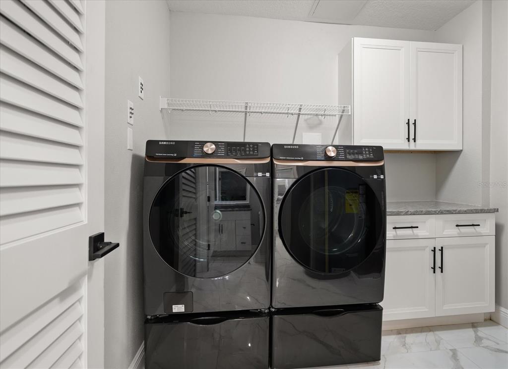 211 Dolphin Point, Unit 301 Clearwater, FL 33767 - Photo 27 of 48 a utility room with dryer and washer