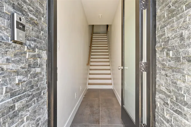 a view of a hallway with windows and stairs