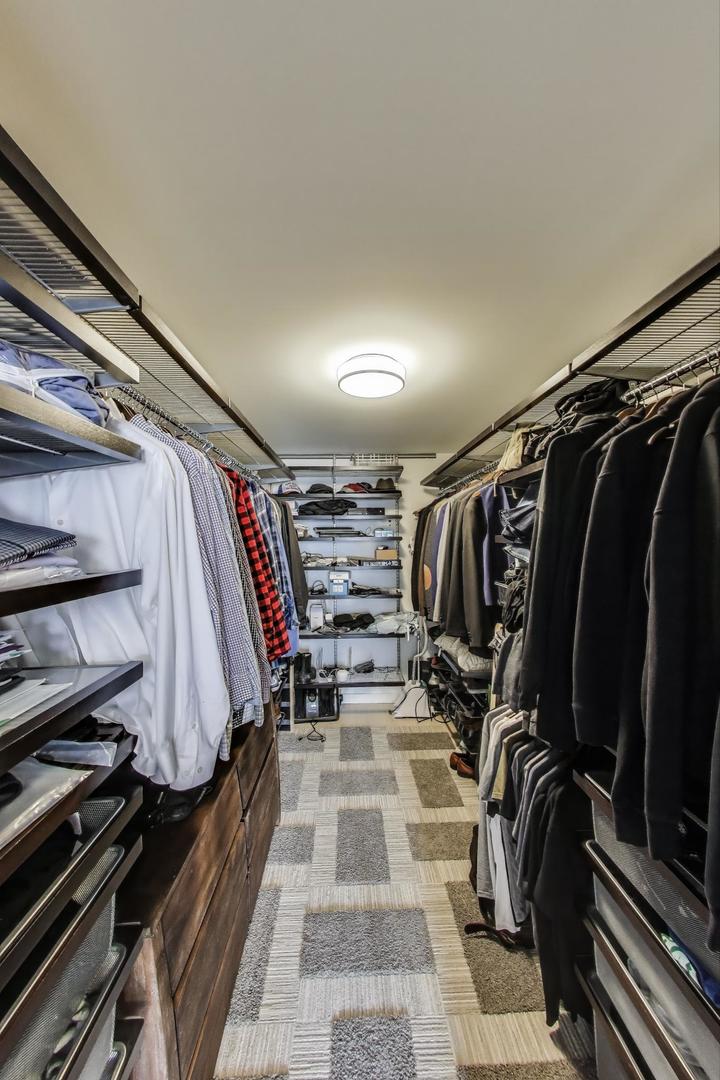 520 North Halsted Street, Unit 410 Chicago, IL 60642 - Photo 12 of 31 a view of walk in closet with clothes and shoes