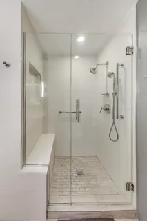 a bathroom with a glass shower door