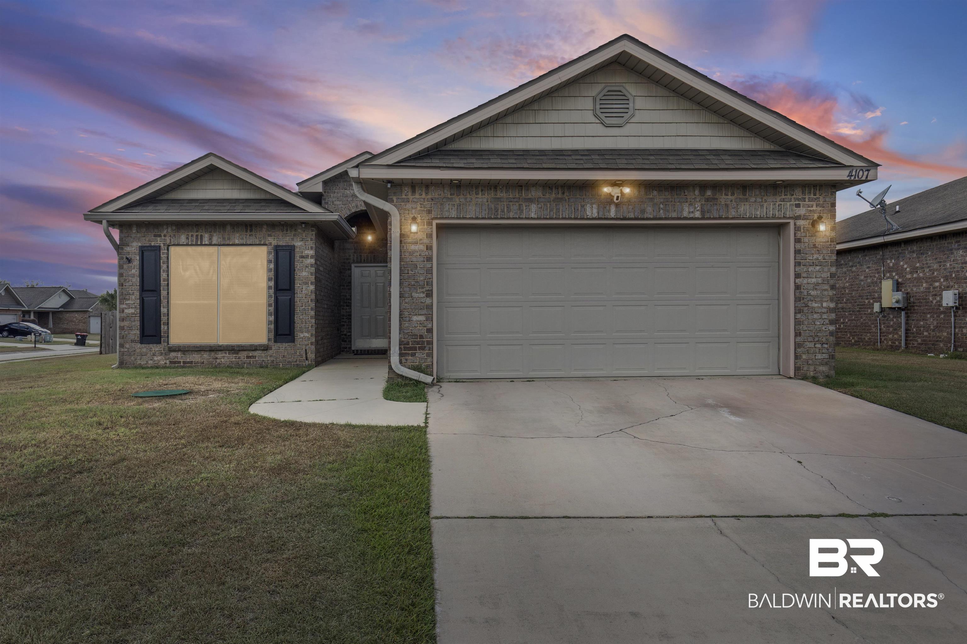 4107 Nottingham Drive Semmes, AL 36575 - Photo 1 of 23 Ranch-style home featuring a lawn, concrete driveway, brick siding, and an attached garage