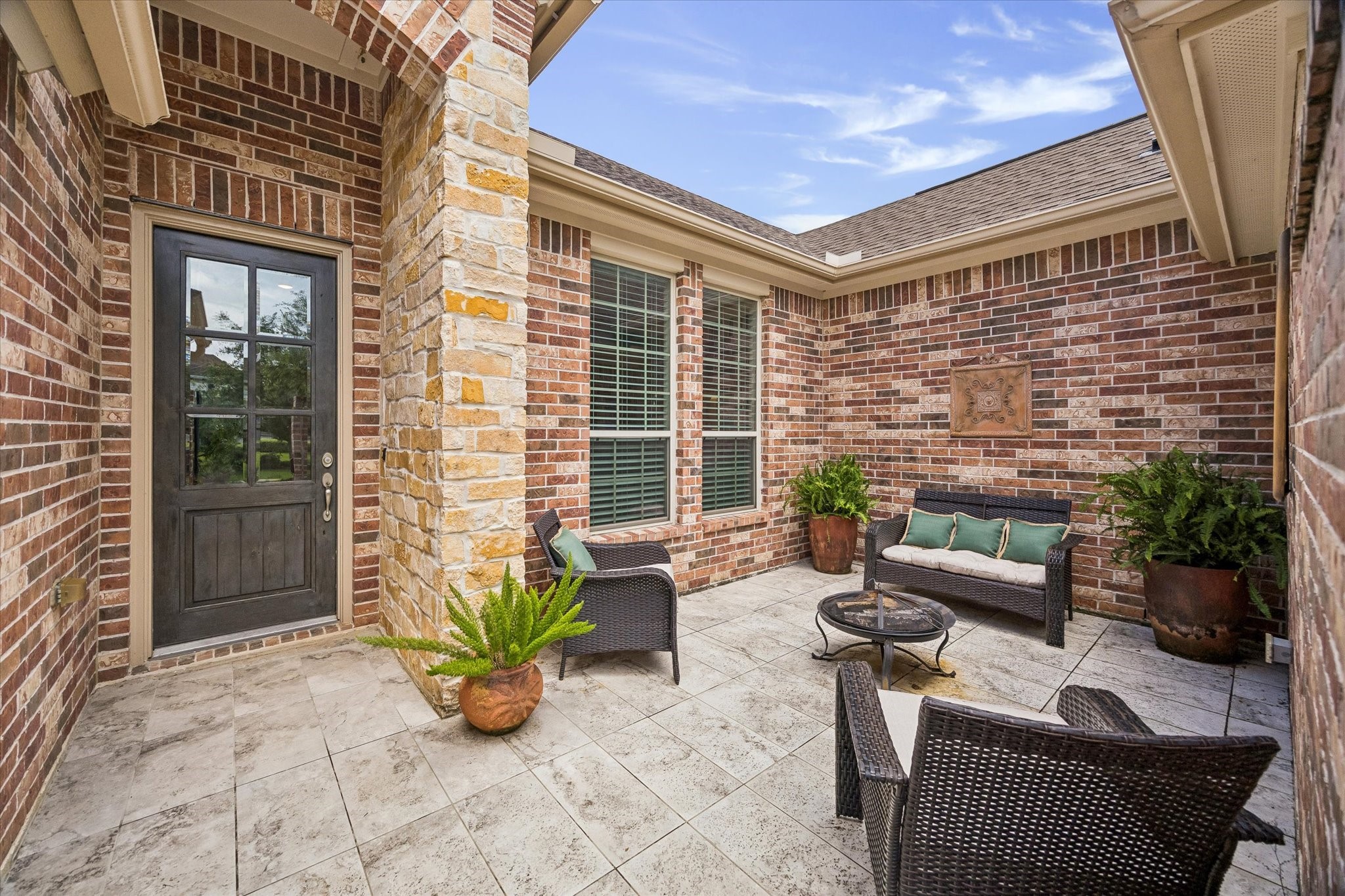 19 Peace Tree Way Tomball, TX 77375 - Photo 4 of 36 Enjoy an early morning cup of coffee or an evening glass of wine in the courtyard found at the entrance to the home.