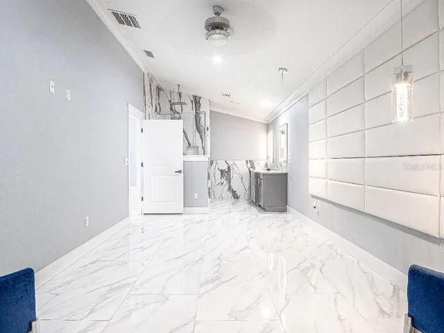 a view of a utility room with closet and windows