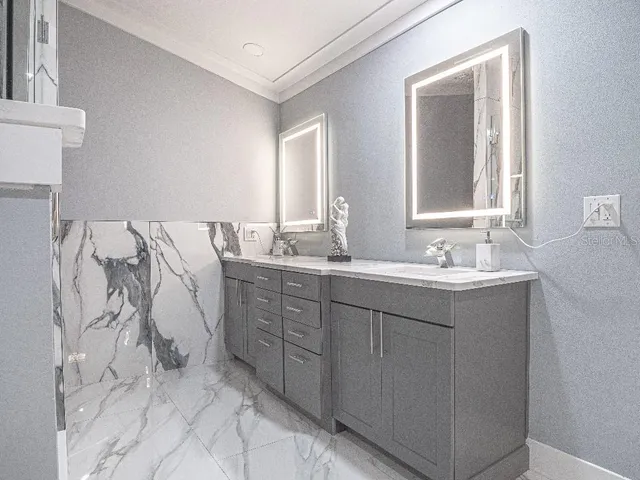 a bathroom with a double vanity sink mirror and