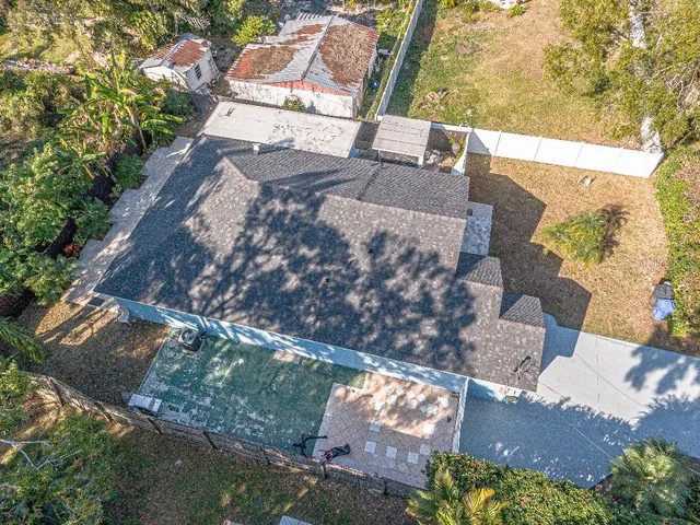 an aerial view of a house with a yard basket ball court and outdoor seating