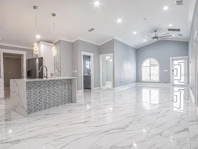 a large room with a large window and chandelier