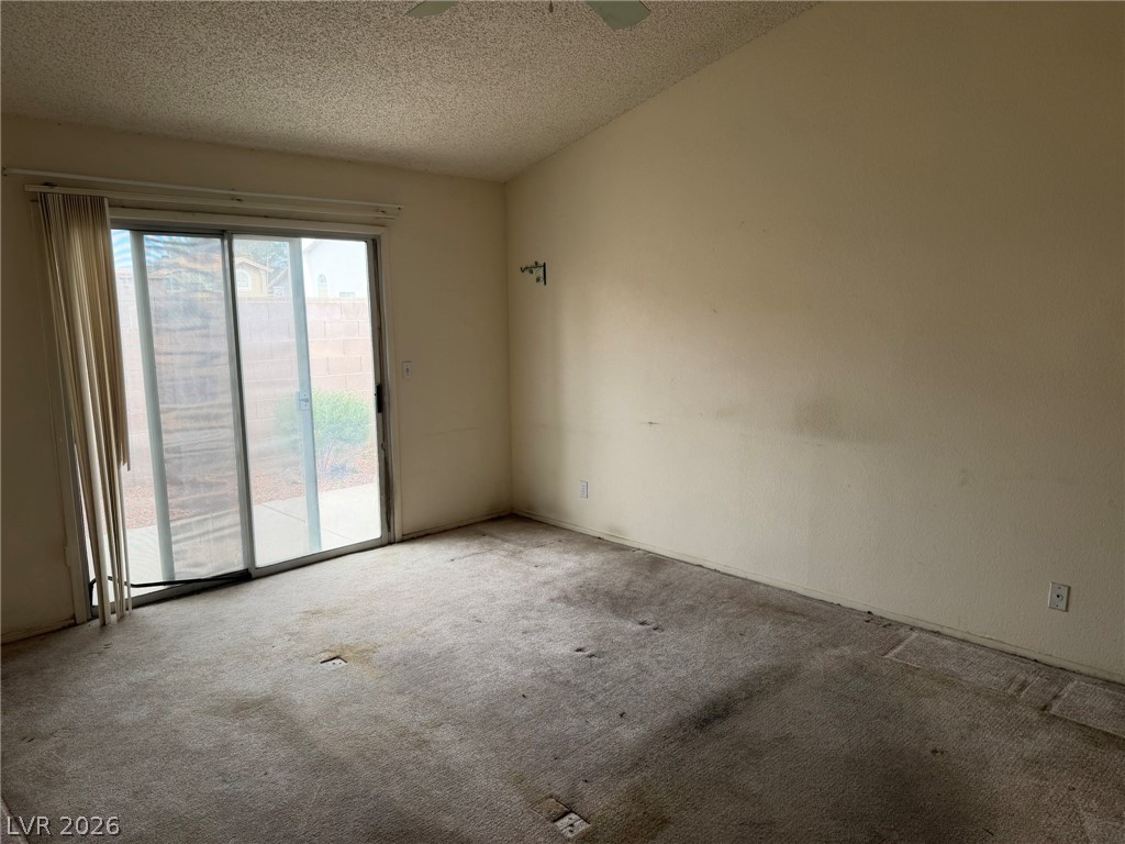 277 Gentle Bay Avenue Henderson, NV 89074 - Photo 6 of 43 This versatile room features an expansive sliding glass door, offering seamless indoor-outdoor living.