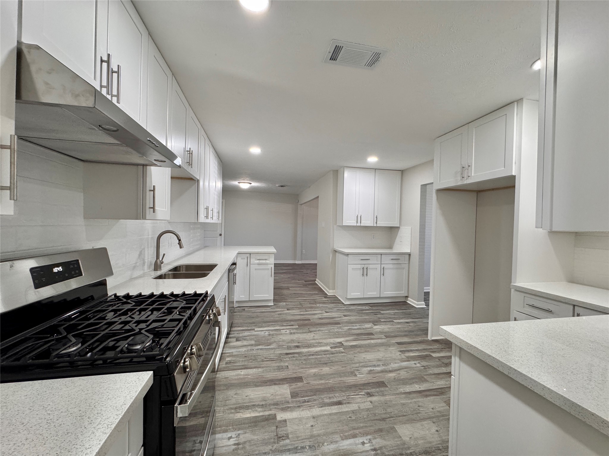 a kitchen with stainless steel appliances granite countertop a stove and a refrigerator