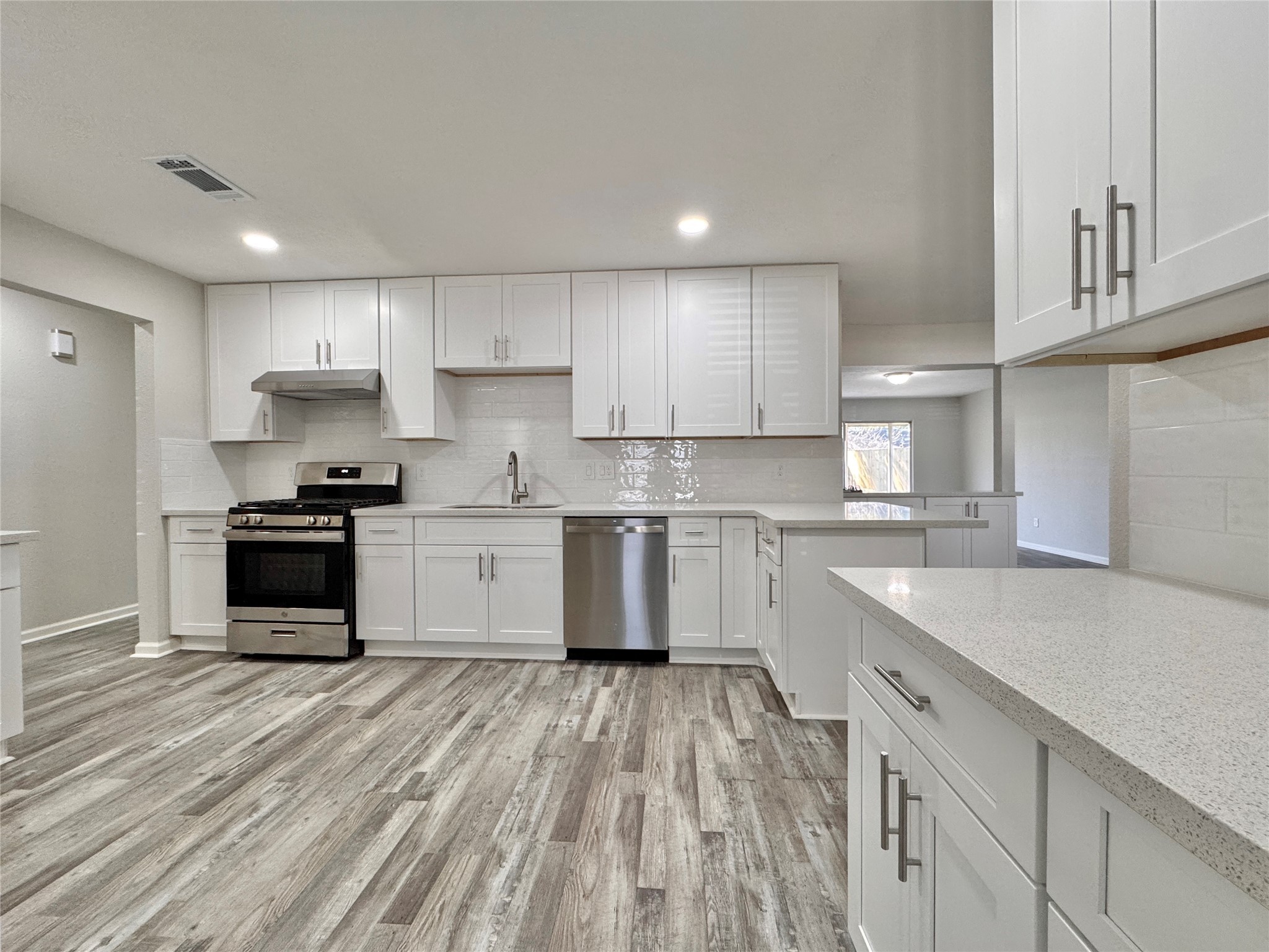 5115 Hialeah Drive Houston, TX 77092 - Photo 2 of 21 a kitchen with a sink a stove top oven and cabinets