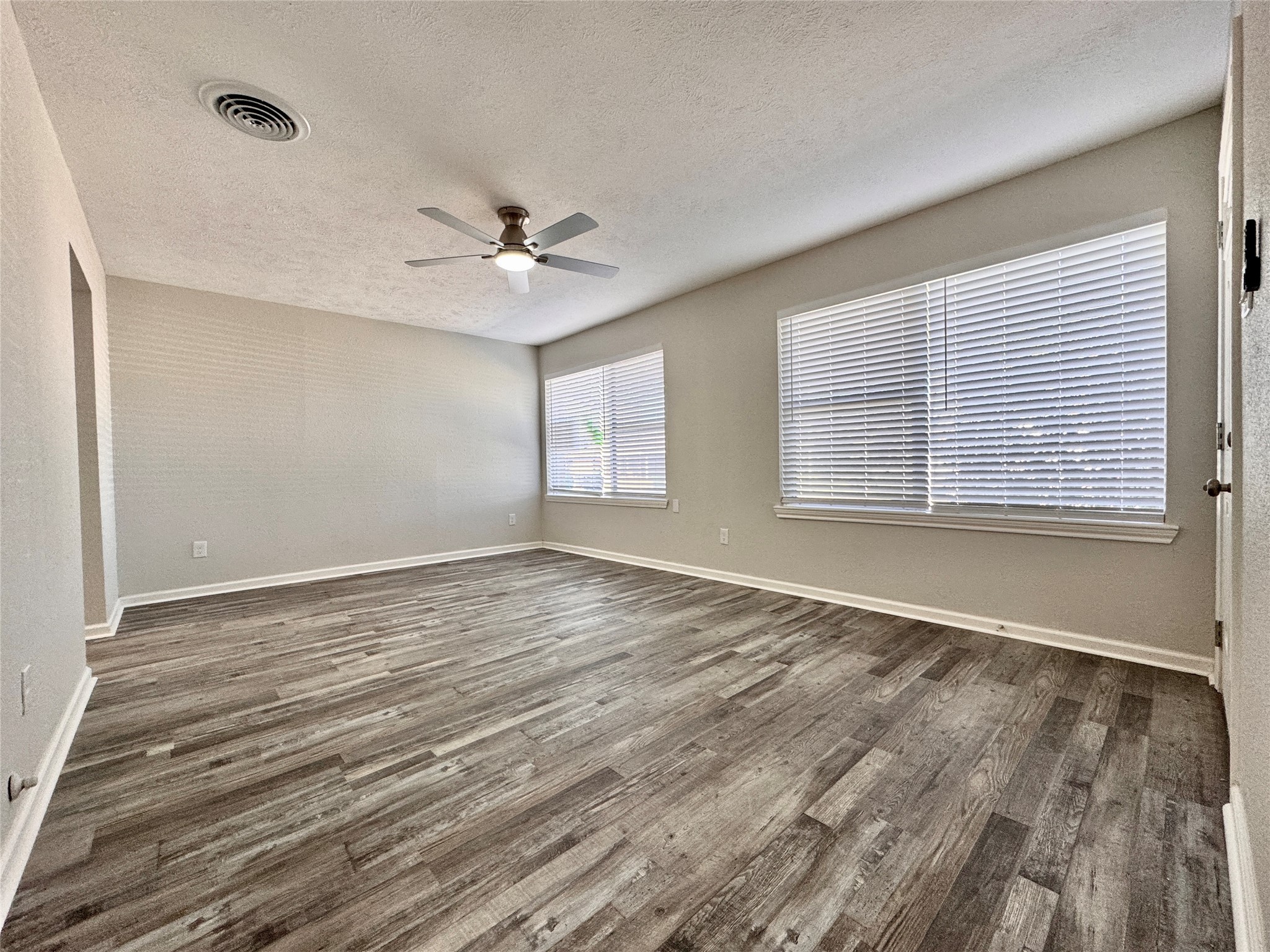 5115 Hialeah Drive Houston, TX 77092 - Photo 5 of 21 wooden floor in an empty room with a window