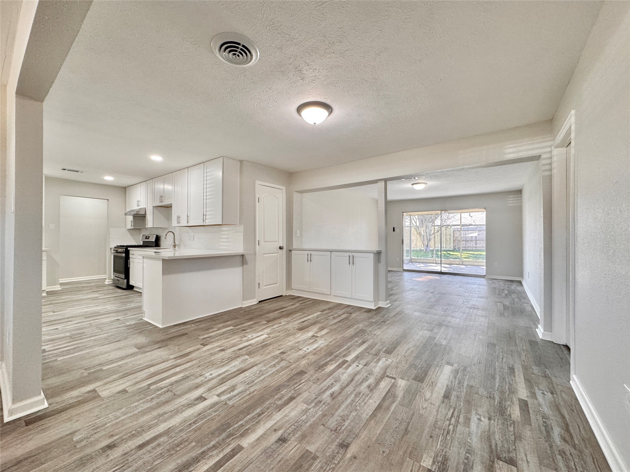 5115 Hialeah Drive Houston, TX 77092 - Photo 6 of 21 a view of kitchen with wooden floor electronic appliances and window