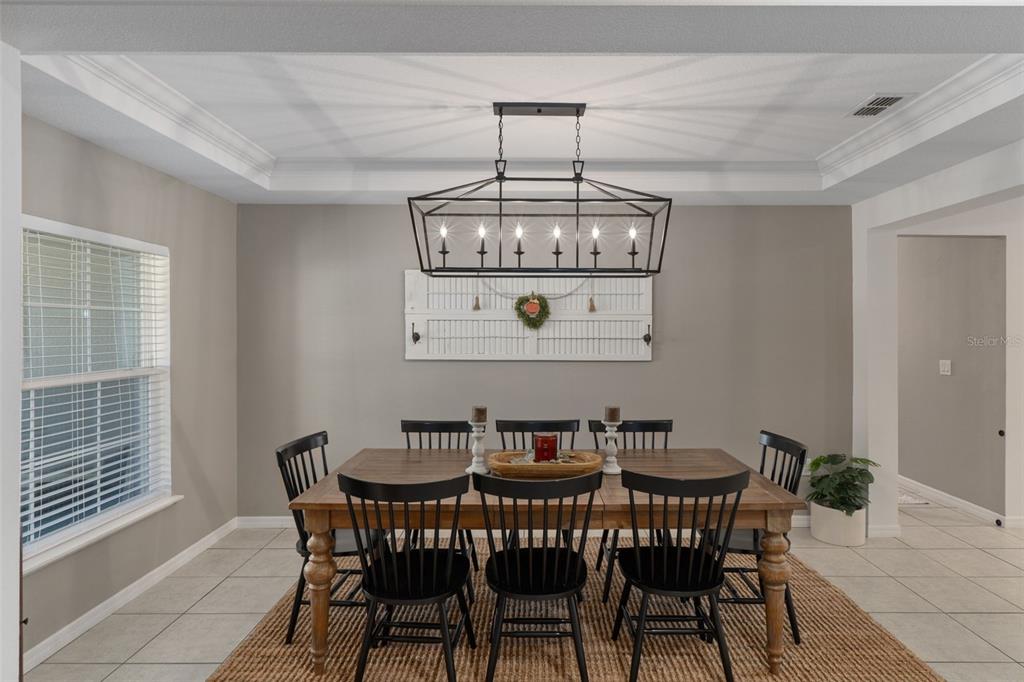 3313 Dorian Avenue Spring Hill, FL 34606 - Photo 13 of 57 a view of a dining room with furniture wooden floor and chandelier