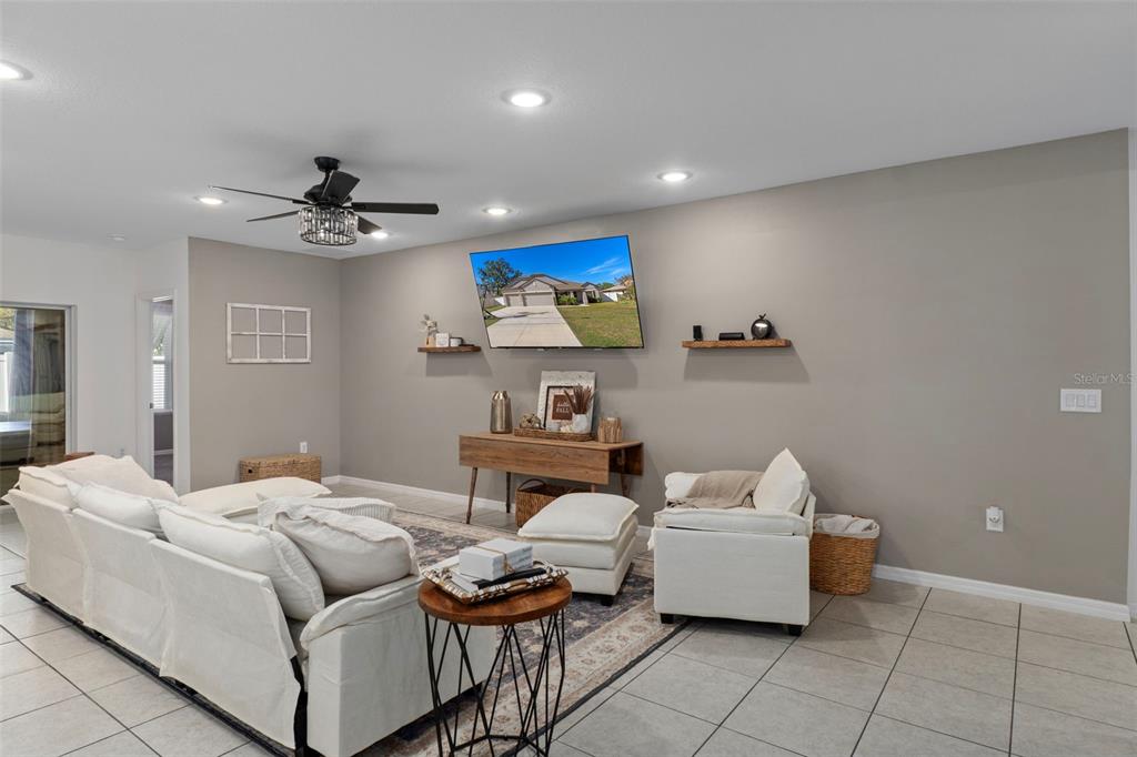 3313 Dorian Avenue Spring Hill, FL 34606 - Photo 18 of 57 a living room with furniture and a ceiling fan