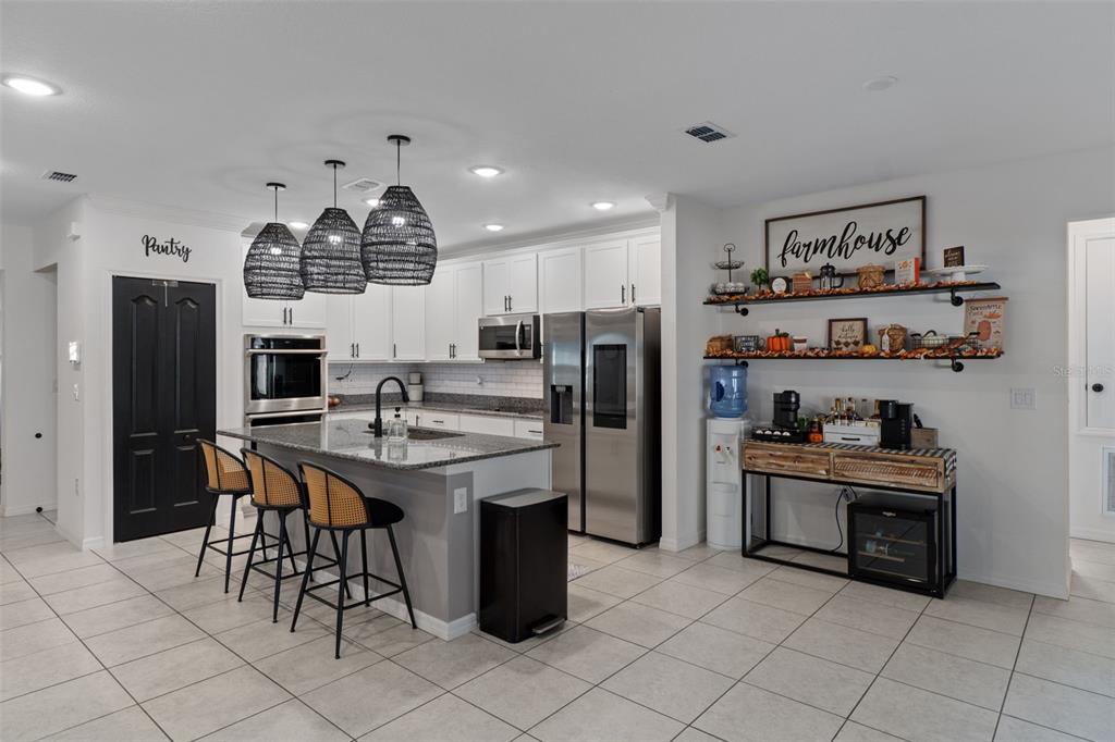 3313 Dorian Avenue Spring Hill, FL 34606 - Photo 21 of 57 a kitchen with stainless steel appliances granite countertop a sink and a refrigerator