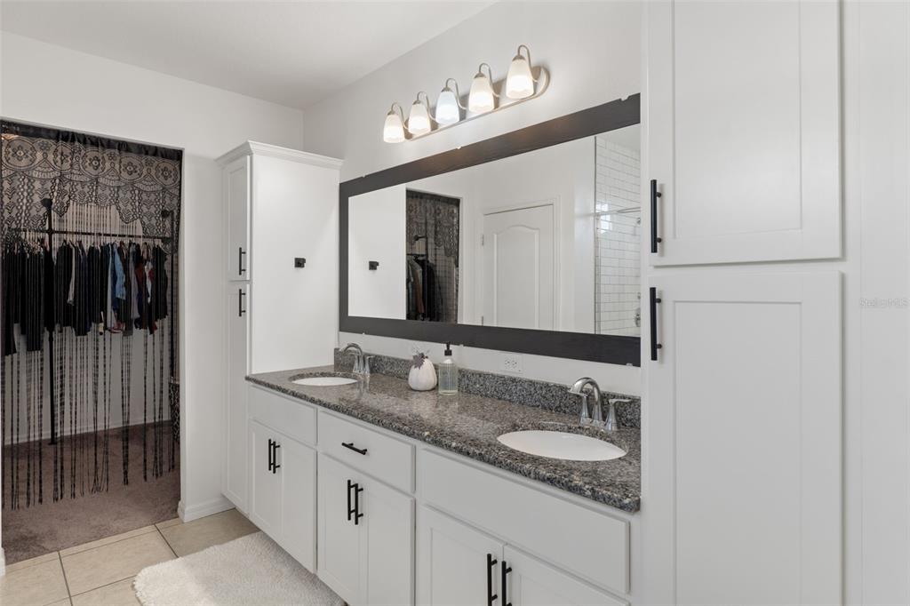 3313 Dorian Avenue Spring Hill, FL 34606 - Photo 24 of 57 a bathroom with a granite countertop sink vanity and mirror