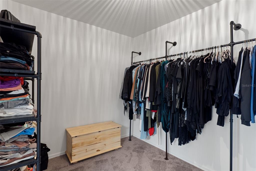 3313 Dorian Avenue Spring Hill, FL 34606 - Photo 26 of 57 a view of walk in closet with clothes and shoes