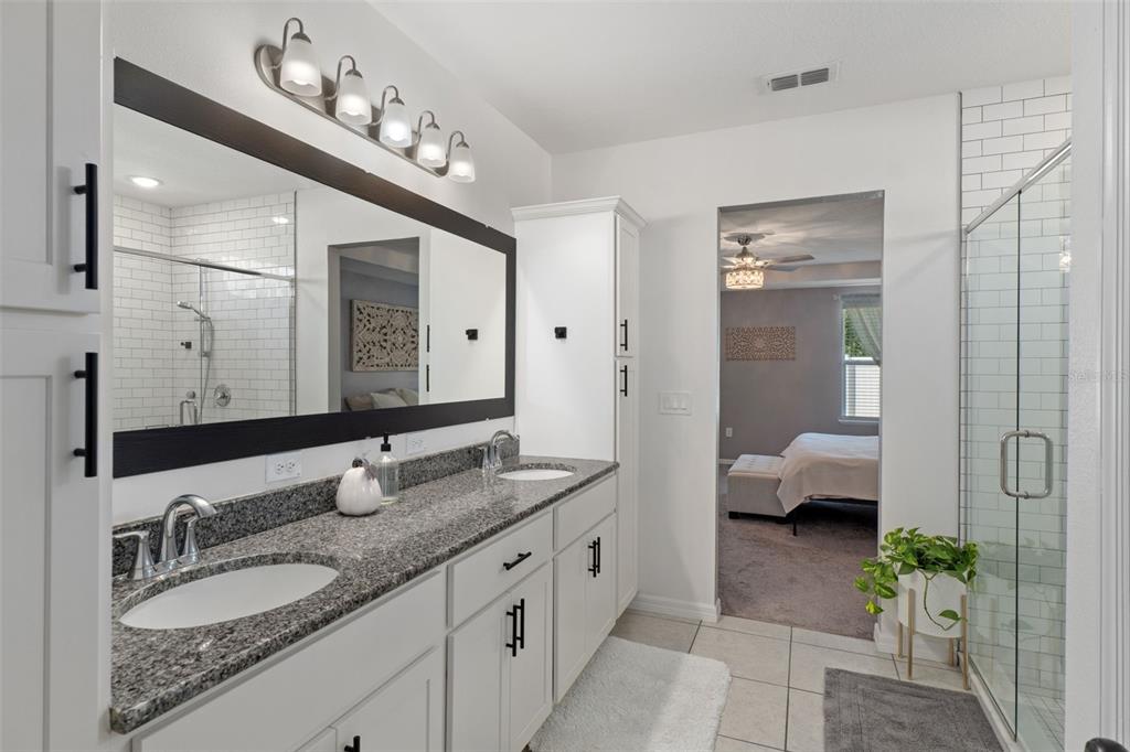 3313 Dorian Avenue Spring Hill, FL 34606 - Photo 27 of 57 a spacious bathroom with a double vanity sink and a mirror