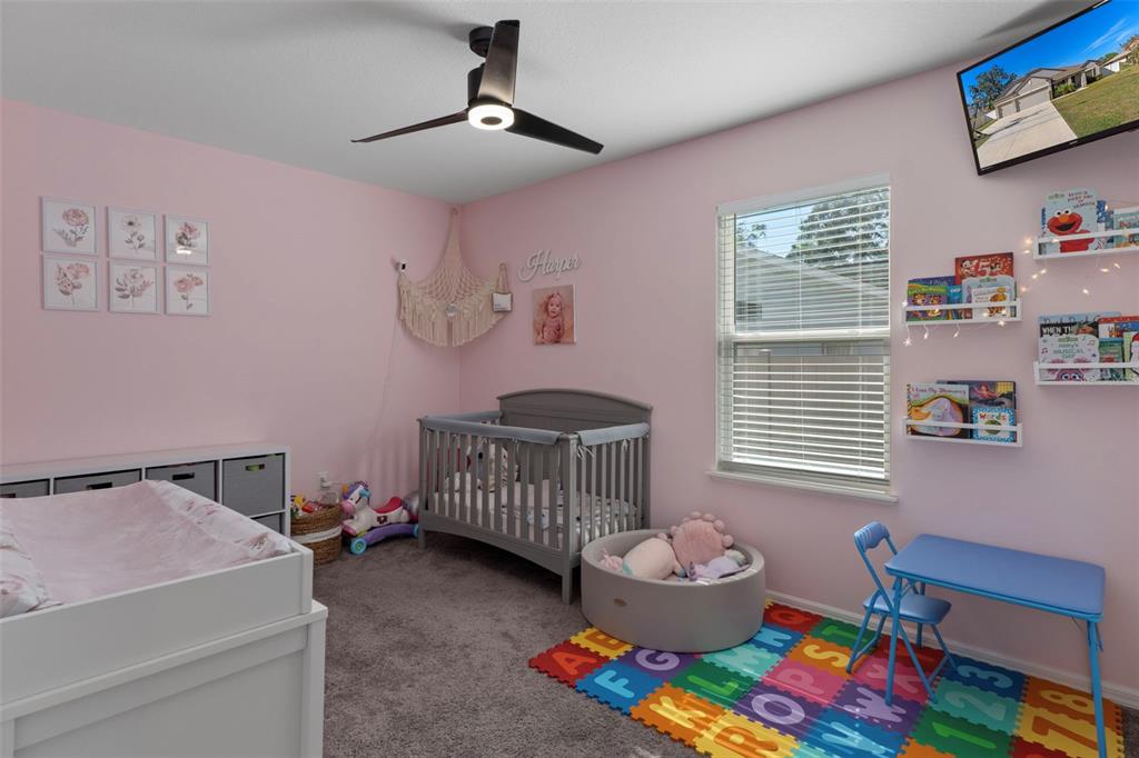 3313 Dorian Avenue Spring Hill, FL 34606 - Photo 30 of 57 a bedroom with a bed and wooden floor