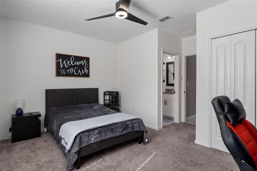 3313 Dorian Avenue Spring Hill, FL 34606 - Photo 36 of 57 a bedroom with a bed and a walk in closet