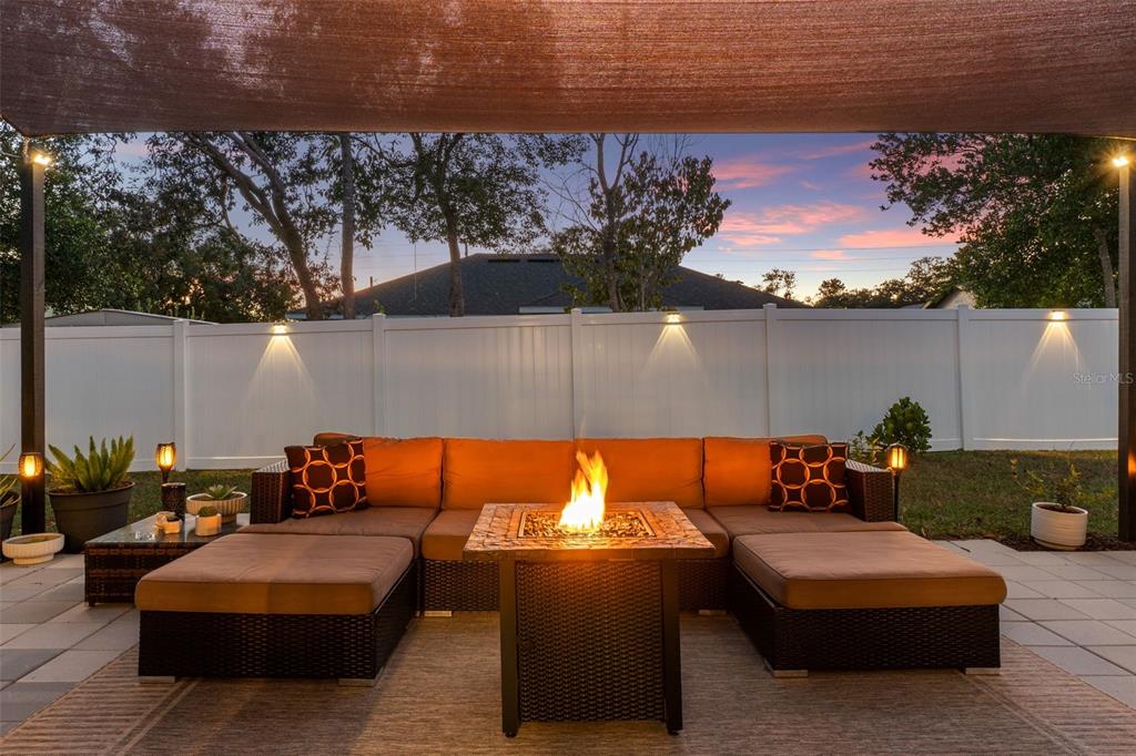 3313 Dorian Avenue Spring Hill, FL 34606 - Photo 45 of 57 an outdoor living space with furniture and a fireplace