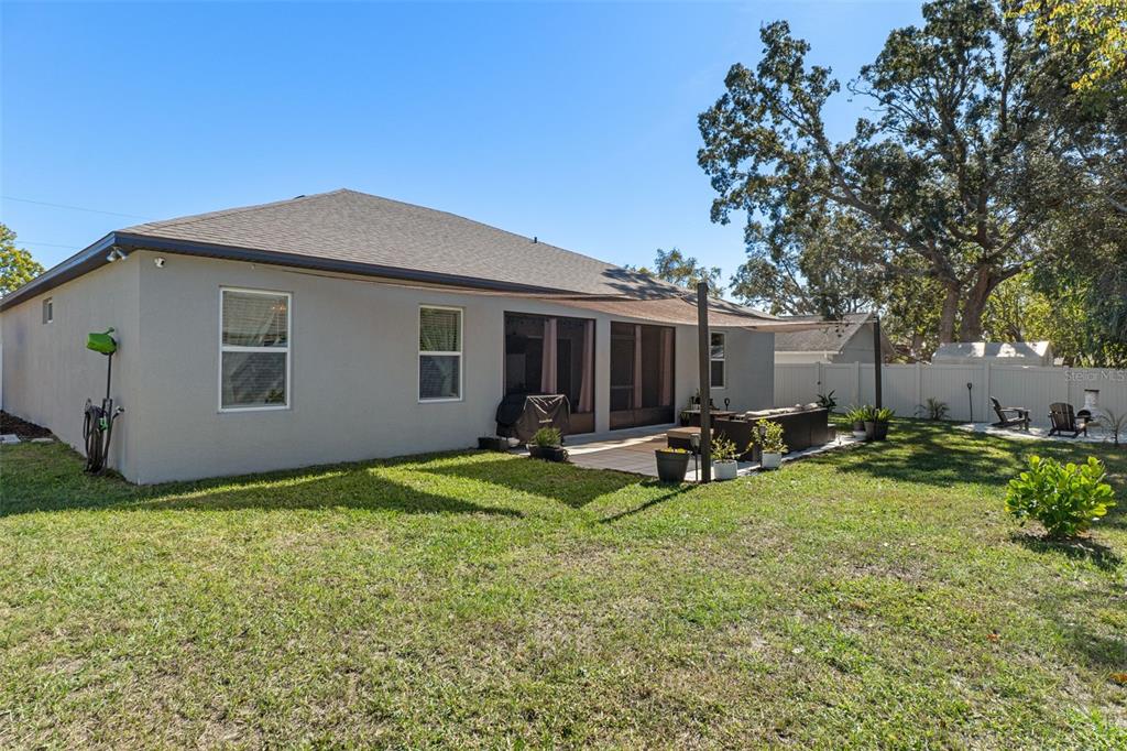 3313 Dorian Avenue Spring Hill, FL 34606 - Photo 56 of 57 a view of a house with backyard sitting area and garden