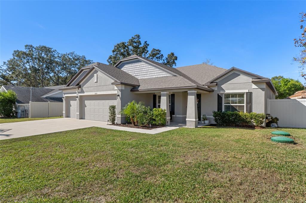 3313 Dorian Avenue Spring Hill, FL 34606 - Photo 8 of 57 a front view of a house with a yard