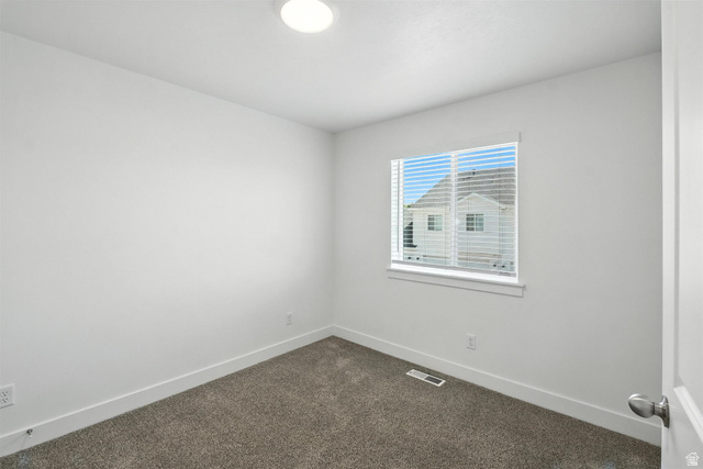 1221 West 1870 South Logan, UT 84321 - Photo 8 of 20 Neutral wall paint in a matte finish, recessed ceiling lighting, textured carpeting, white window trim, and baseboard molding