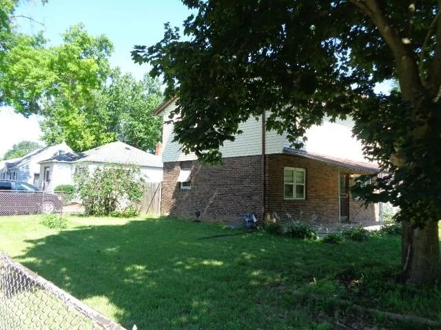 a view of a backyard with a large tree
