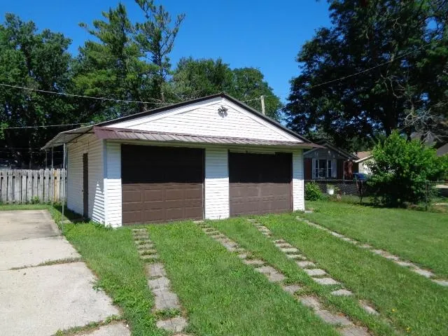 a front view of a house with yard and green space