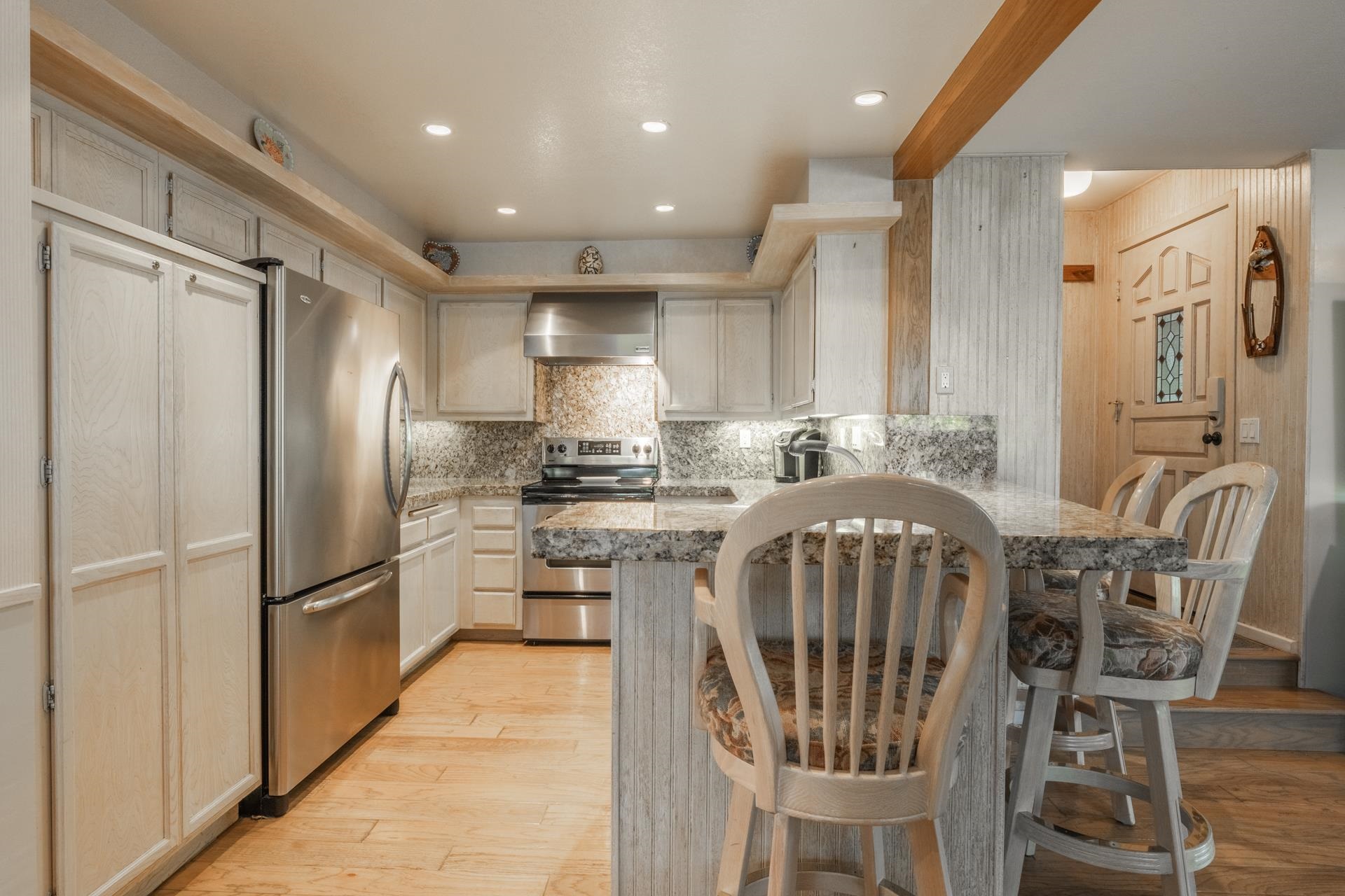 623 Golden Creek Road, Unit 623 Mammoth Lakes, CA 93546 - Photo 12 of 33 a kitchen with stainless steel appliances granite countertop a refrigerator a sink a stove a dining table and chairs