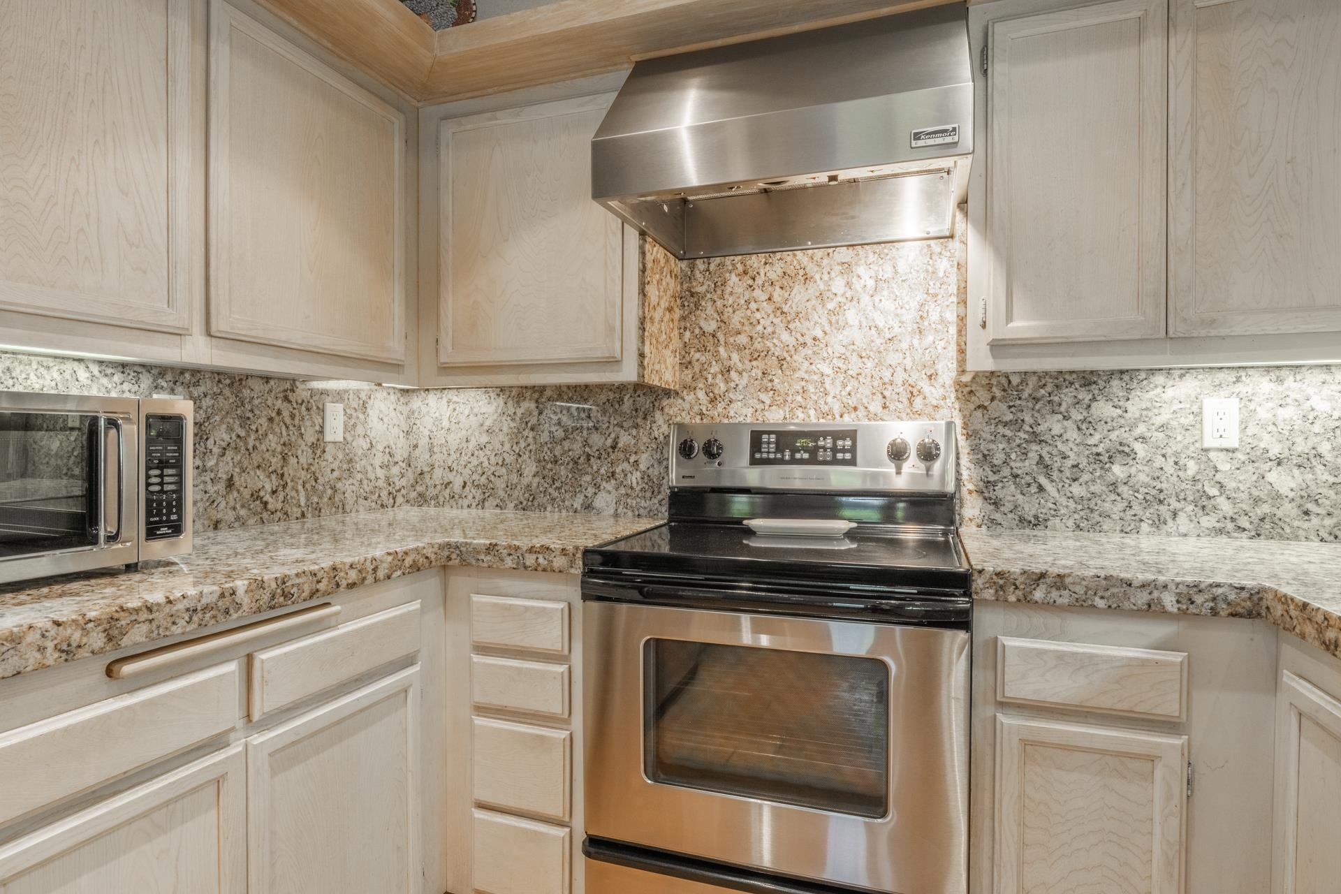 623 Golden Creek Road, Unit 623 Mammoth Lakes, CA 93546 - Photo 14 of 33 a kitchen with granite countertop white cabinets stainless steel appliances and sink
