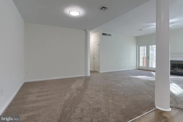 an empty room with windows and entrance