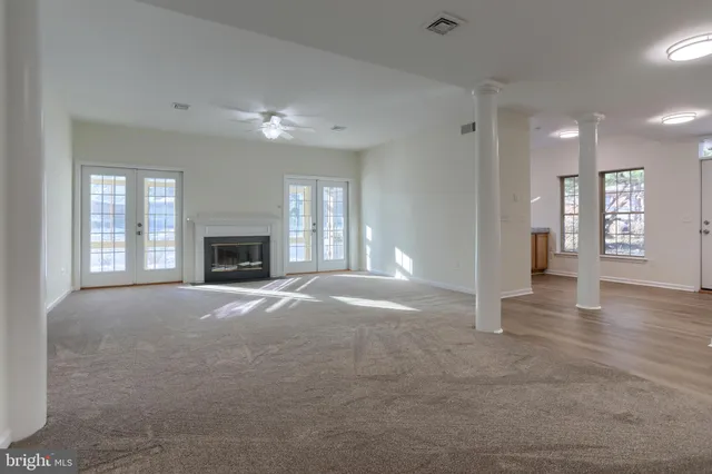 a view of empty room with window and fireplace