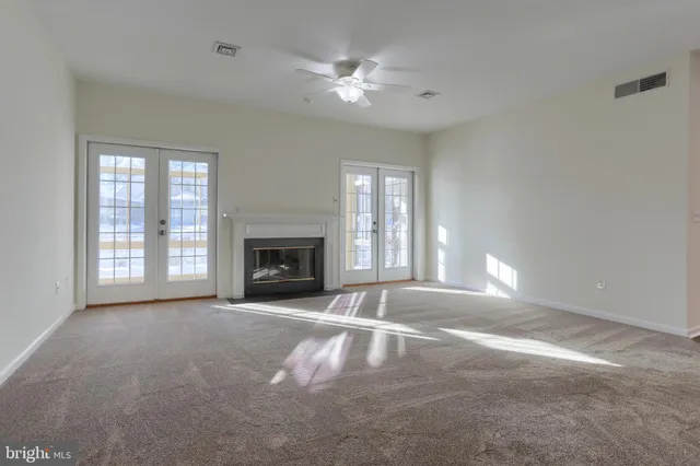 a view of livingroom with fireplace fan and windows
