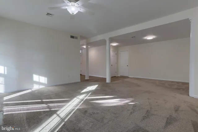 a view of a livingroom with a ceiling fan and window